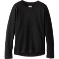 A sporty kid wearing a long sleeve midweight merino wool base layer in solid black.