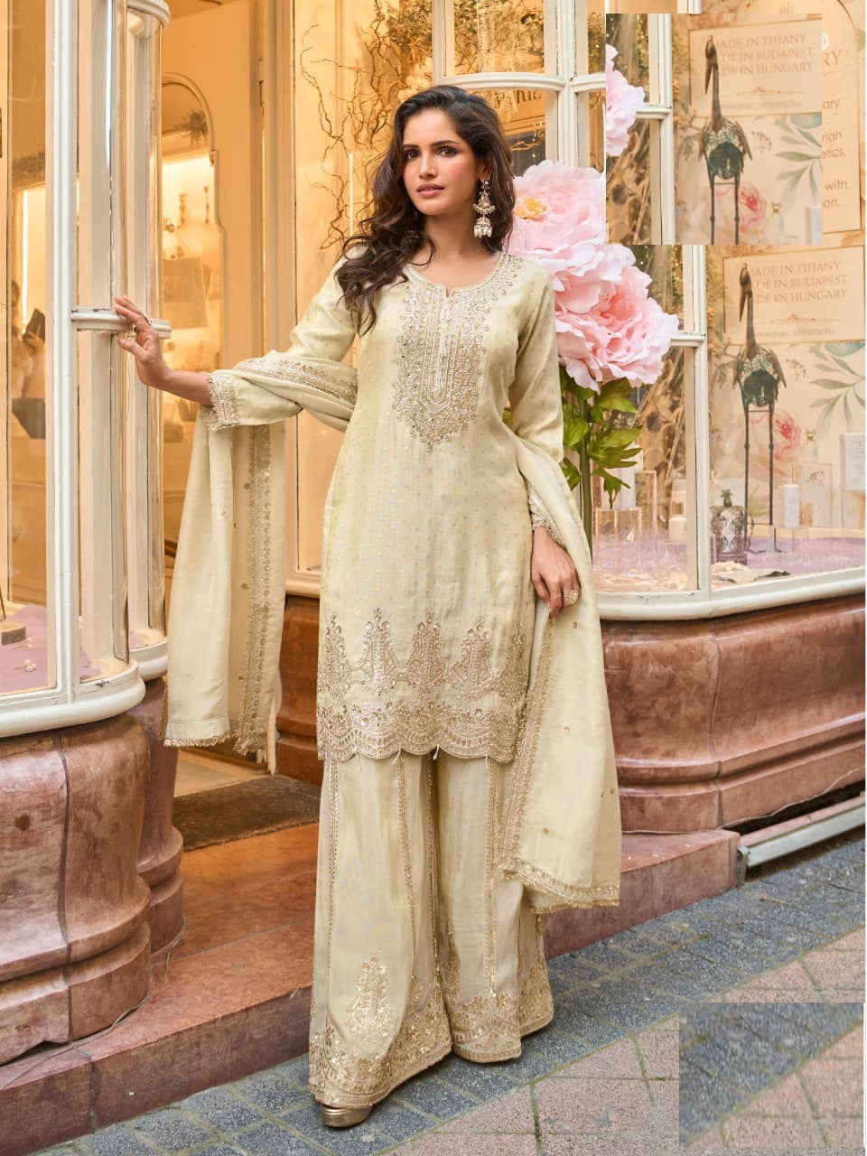 Model wearing a fully stitched ivory shimmer silk straight kurta and sharara pants set