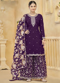 Woman wearing a deep violet Roman silk palazzo suit with gold floral embroidery and matching dupatta.