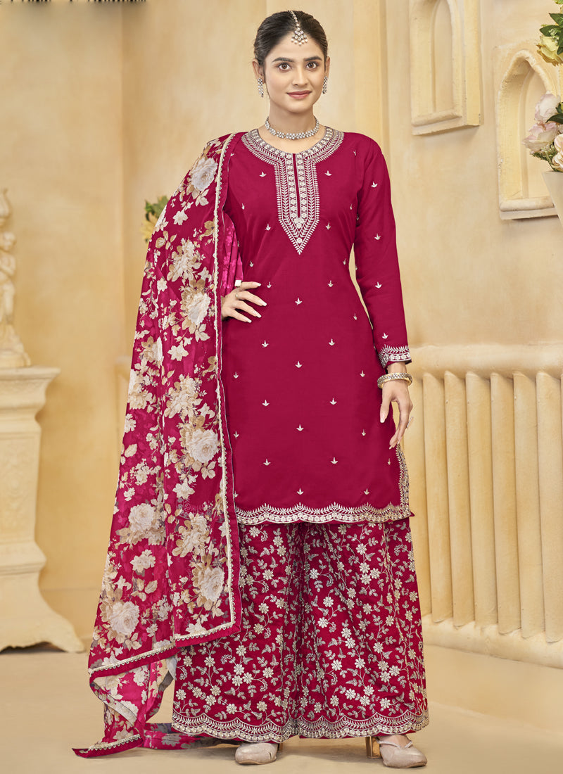 Woman wearing a Rani Pink Roman Silk embroidered palazzo suit with intricate gota patti detail.