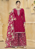 Woman wearing a Rani Pink Roman Silk embroidered palazzo suit with intricate gota patti detail.