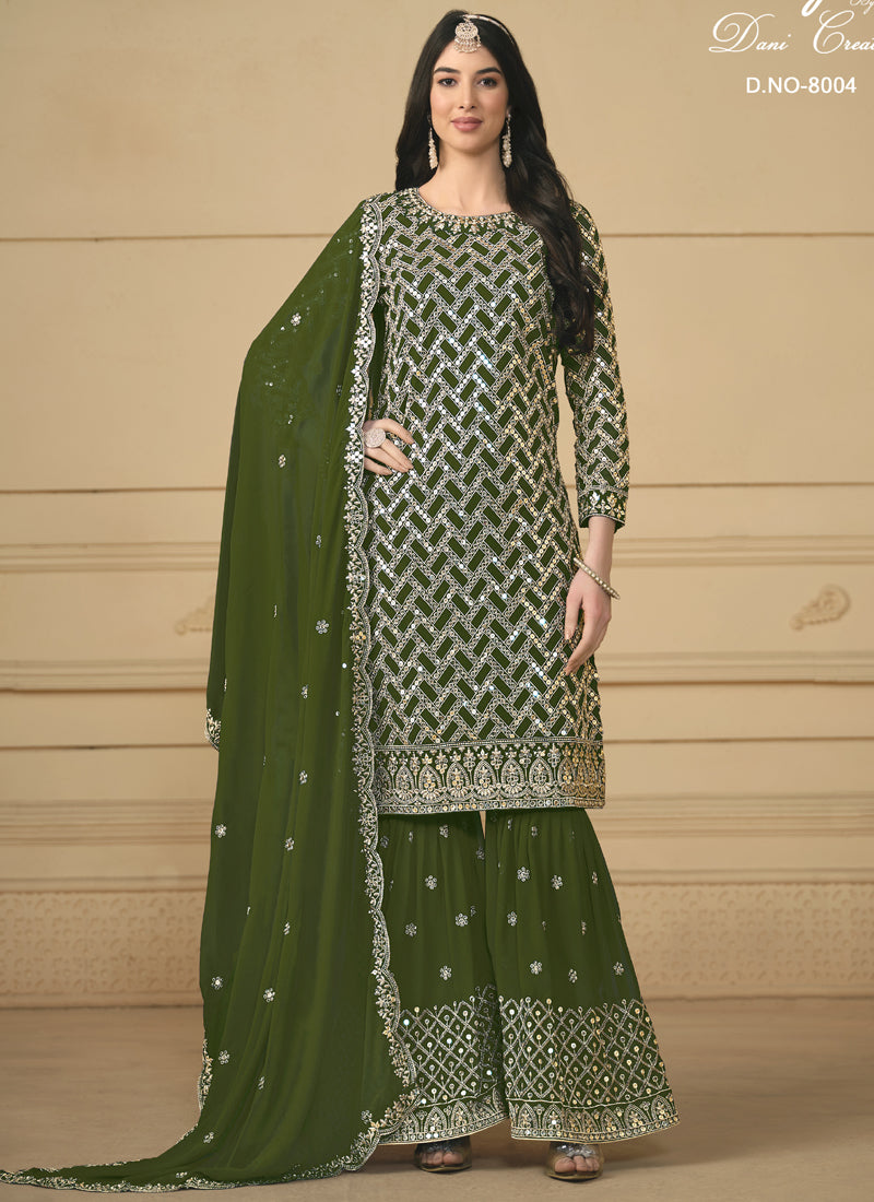 Woman wearing a Mehendi green anarkali sharara suit with metallic gold embroidery and mirror work.