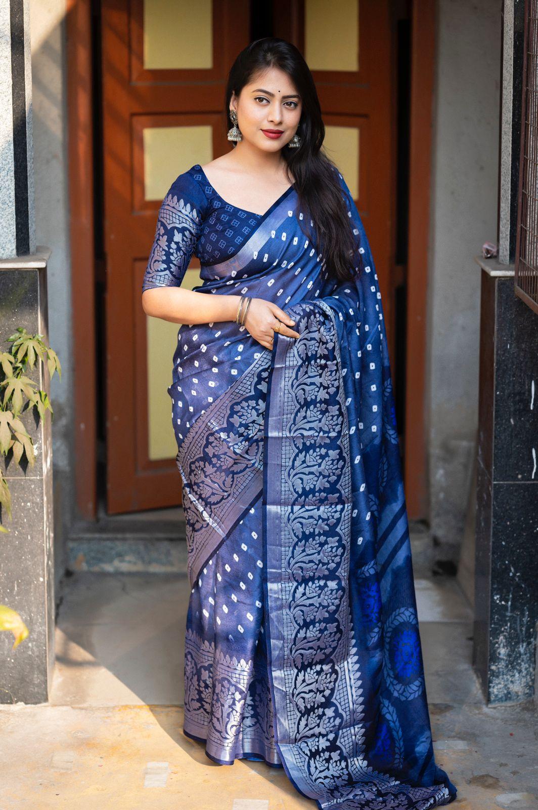 Lightblue jute silk saree with geometric bandhani print and silver cut broaso border.