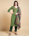 Woman wearing a Mahendi colored rayon kurta set featuring floral embroidery.