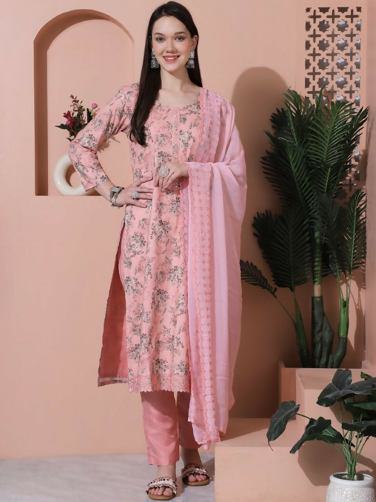 Woman wearing a pink cotton straight kurta with digital floral prints, paired with trousers and a dupatta.