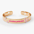 Gold and pink Barbie™ logo cuff bracelet on a neutral background