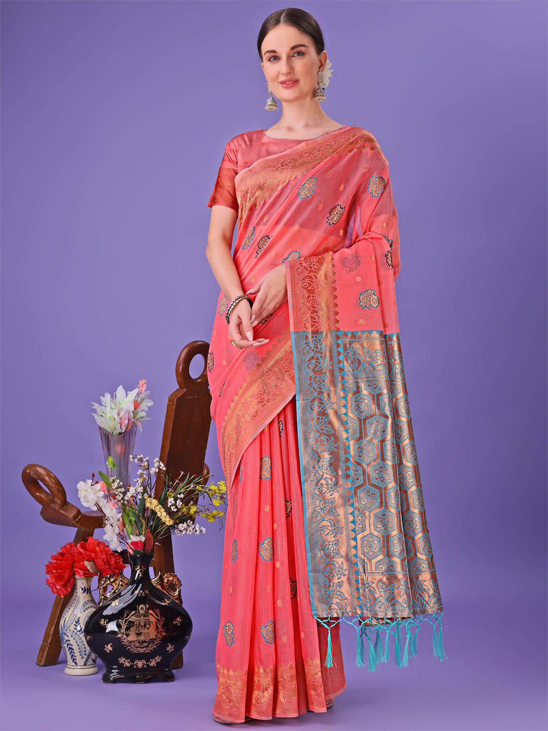 Pink linen cotton saree featuring golden zari work and a rich pallu
