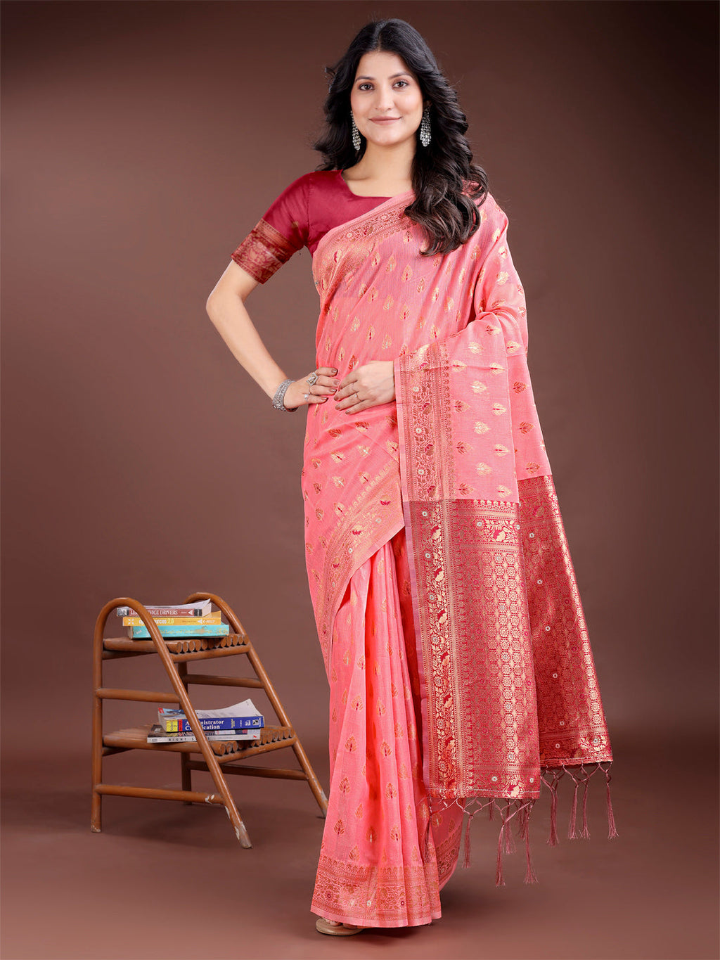 Peach colored cotton saree with subtle buta work and a rich contrasting pallu.