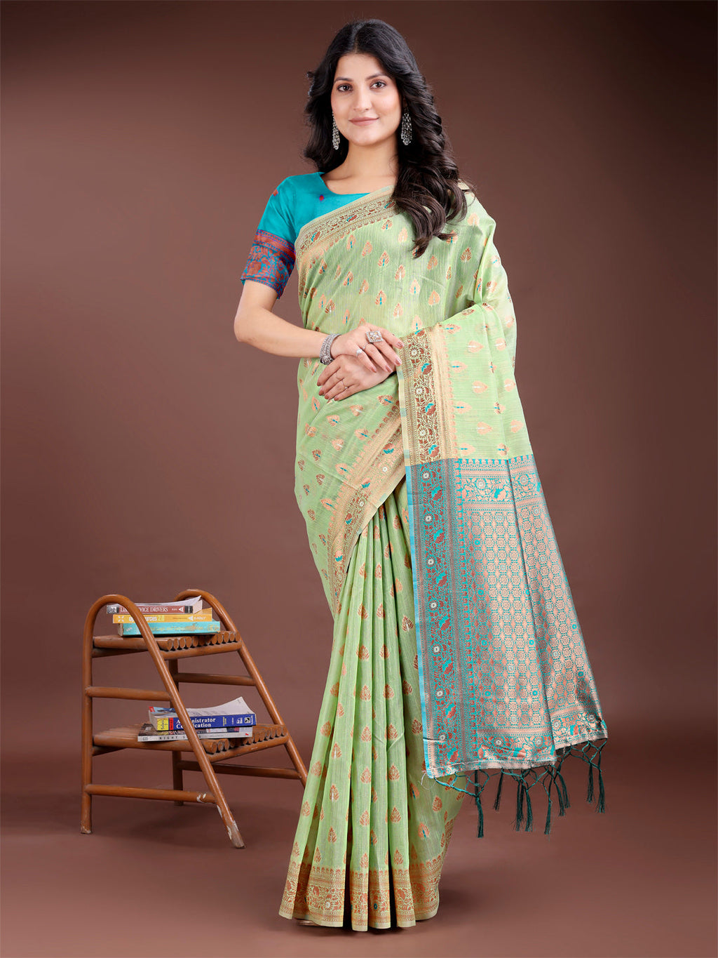 Elegant light green cotton saree with buta work and a contrasting royal hue pallu.