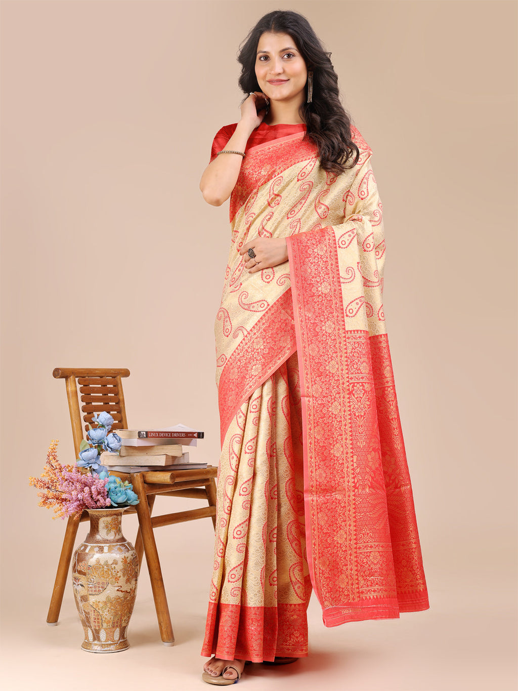 Cream and Red Banarasi Silk Saree with elaborate woven zari border and traditional tassel accents.