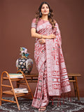 Peach linen cotton saree with woven tribal and geometric patterns.