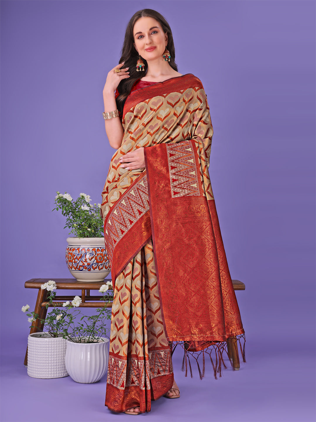 Woman wearing a Radiant Lichi Silk Saree in beige and red with gold geometric patterns