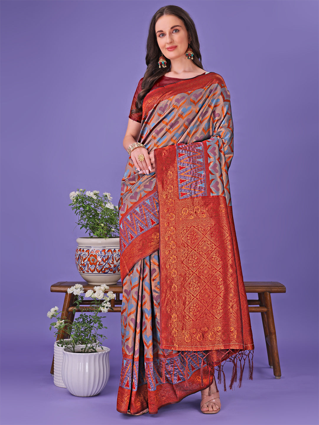 Elegant Lichi Silk Saree in maroon and blue with detailed gold geometric patterns for festive occasions.