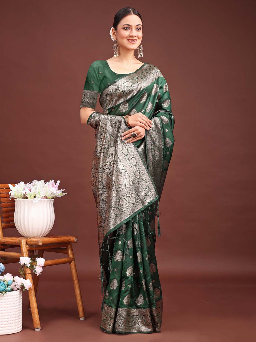 A beautiful dark green Banarasi silk saree with detailed gold zari weaving patterns.