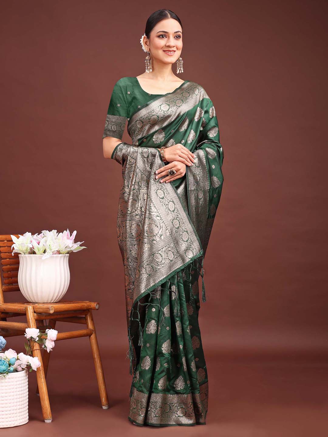 A beautiful dark green Banarasi silk saree with detailed gold zari weaving patterns.