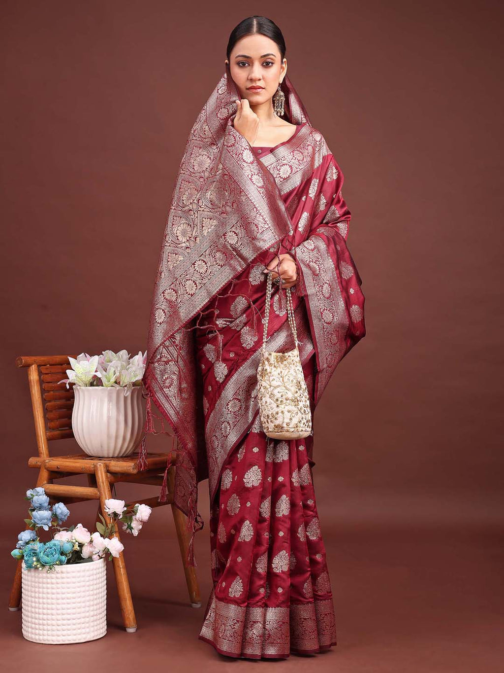 Deep maroon Banarasi silk saree featuring traditional gold zari work
