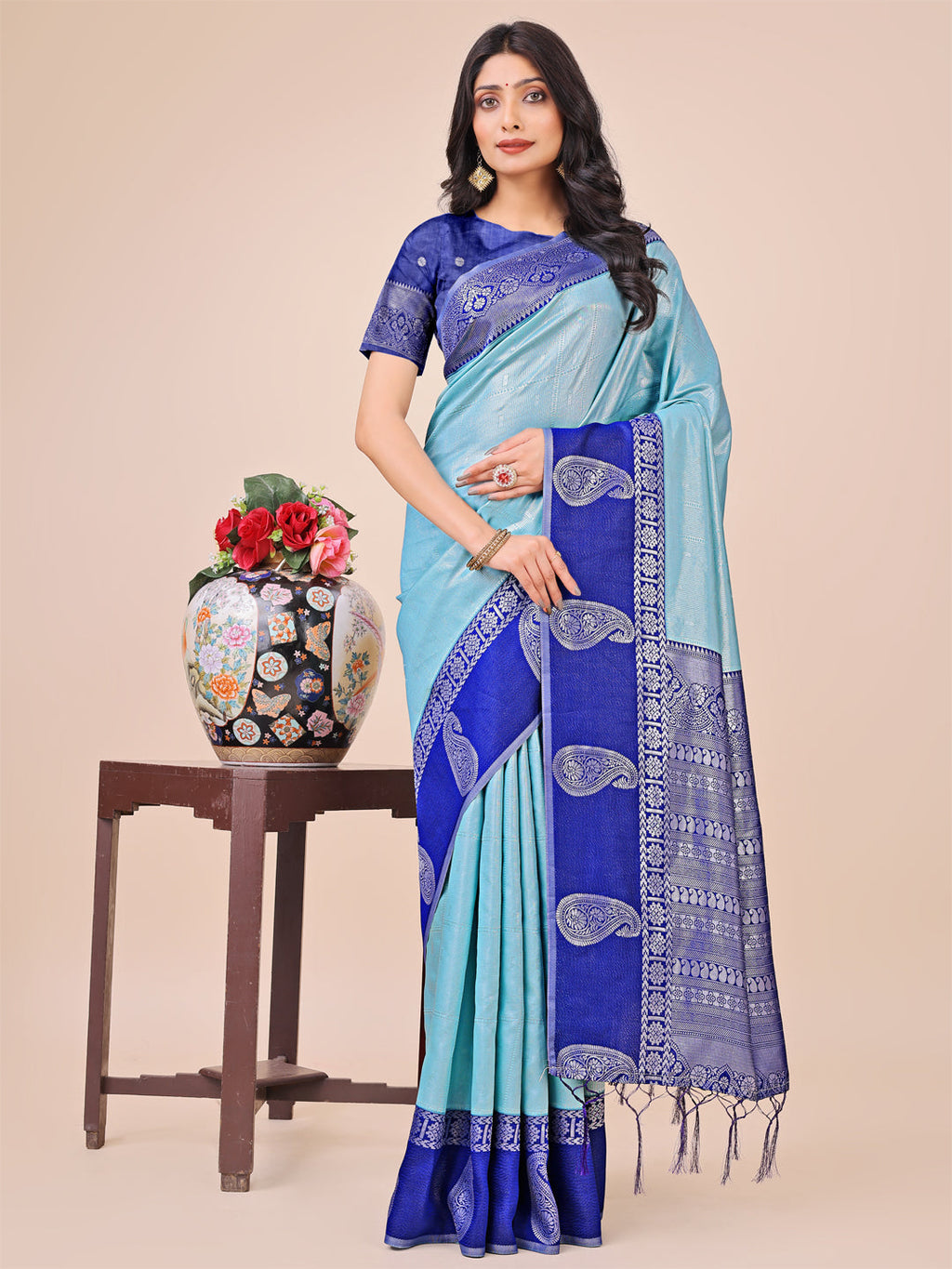 Dual-tone teal silk saree with intricate paisley motifs and a rich woven border.