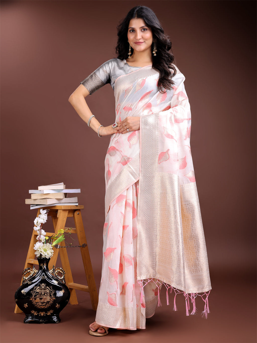 White and pink cotton saree with zari woven borders and decorative tassels