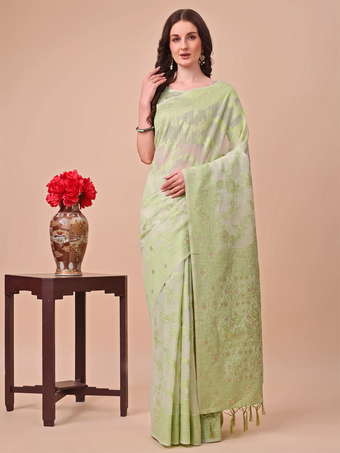 Beige and light green Banarasi cotton saree with floral zari motifs and traditional pallu