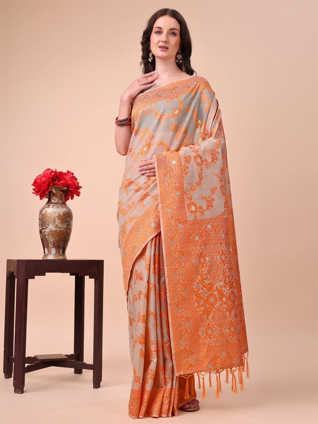 Beige and orange Banarasi cotton saree with floral zari patterns and traditional pallu