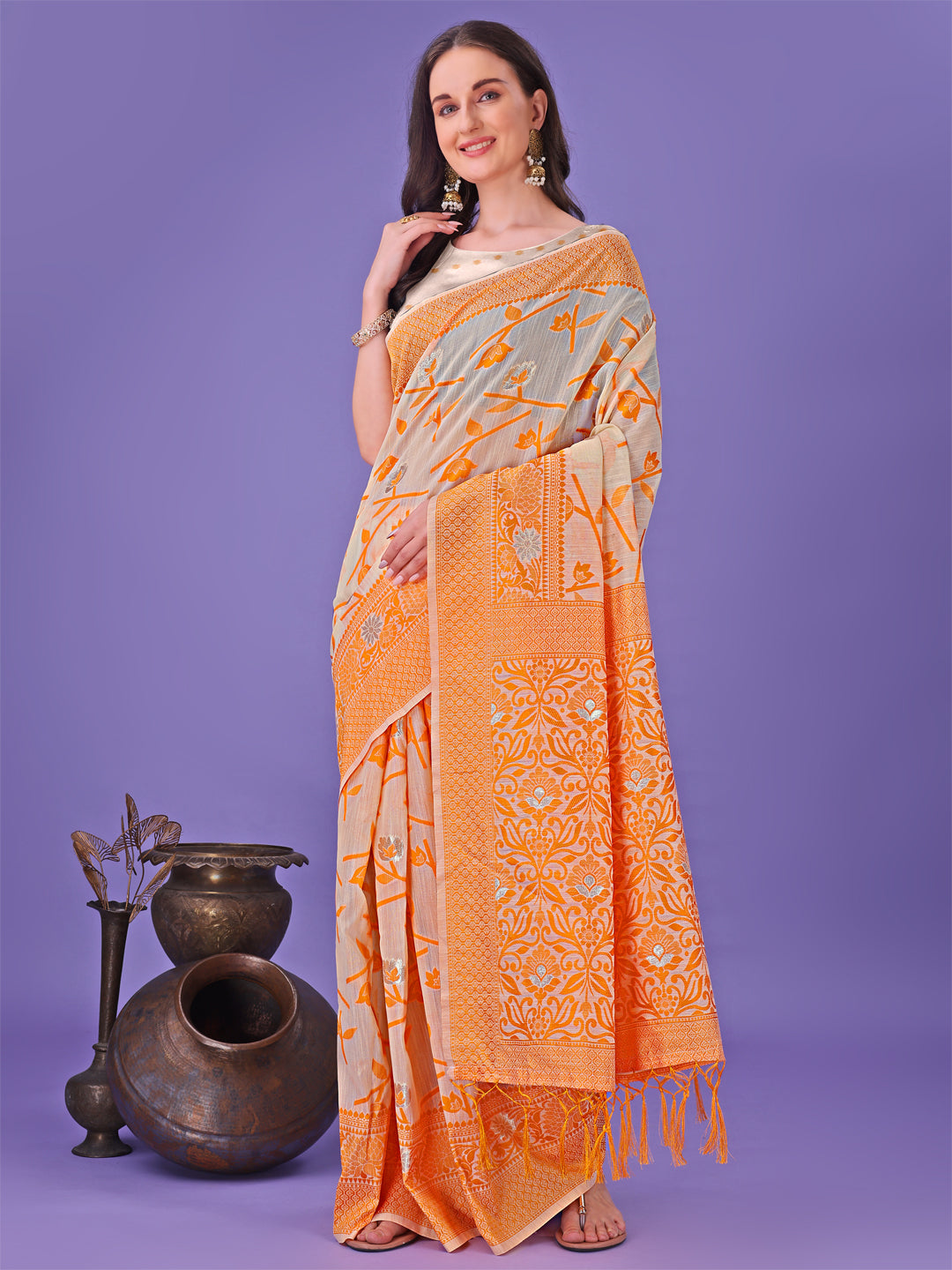 Vibrant orange Lichi silk saree with delicate floral motifs and a decorative tassel pallu