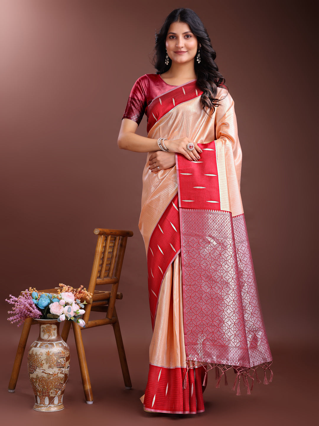 Orange Lichi silk saree with woven zari work and decorative tassels
