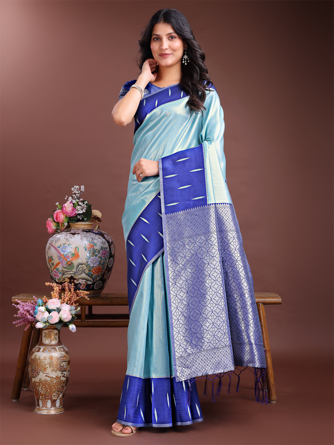 Sea Green Lichi Silk saree with detailed golden Zari work and pallu tassels.