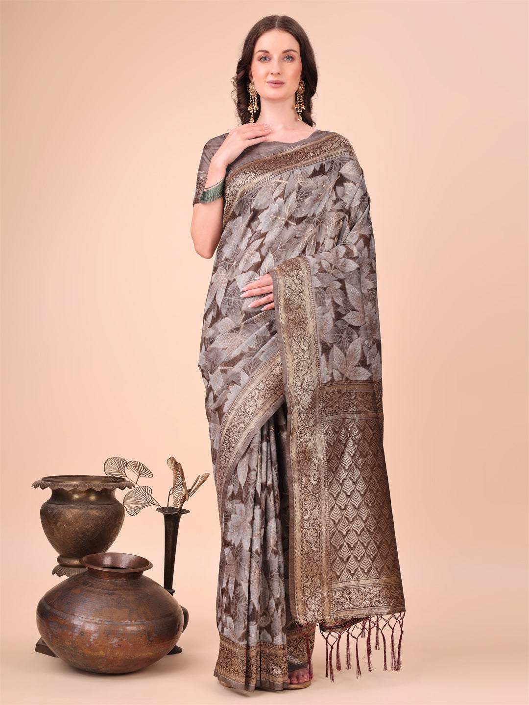 Brown cotton silk saree featuring intricate floral patterns and a richly woven pallu