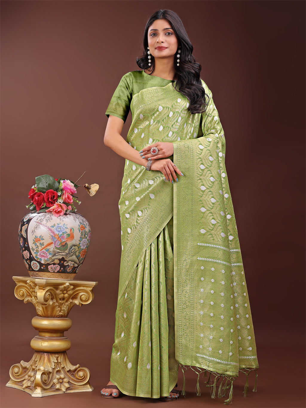 Light green linen saree with silver zari butta and decorative pallu