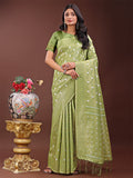 Light green linen saree with silver zari butta and decorative pallu