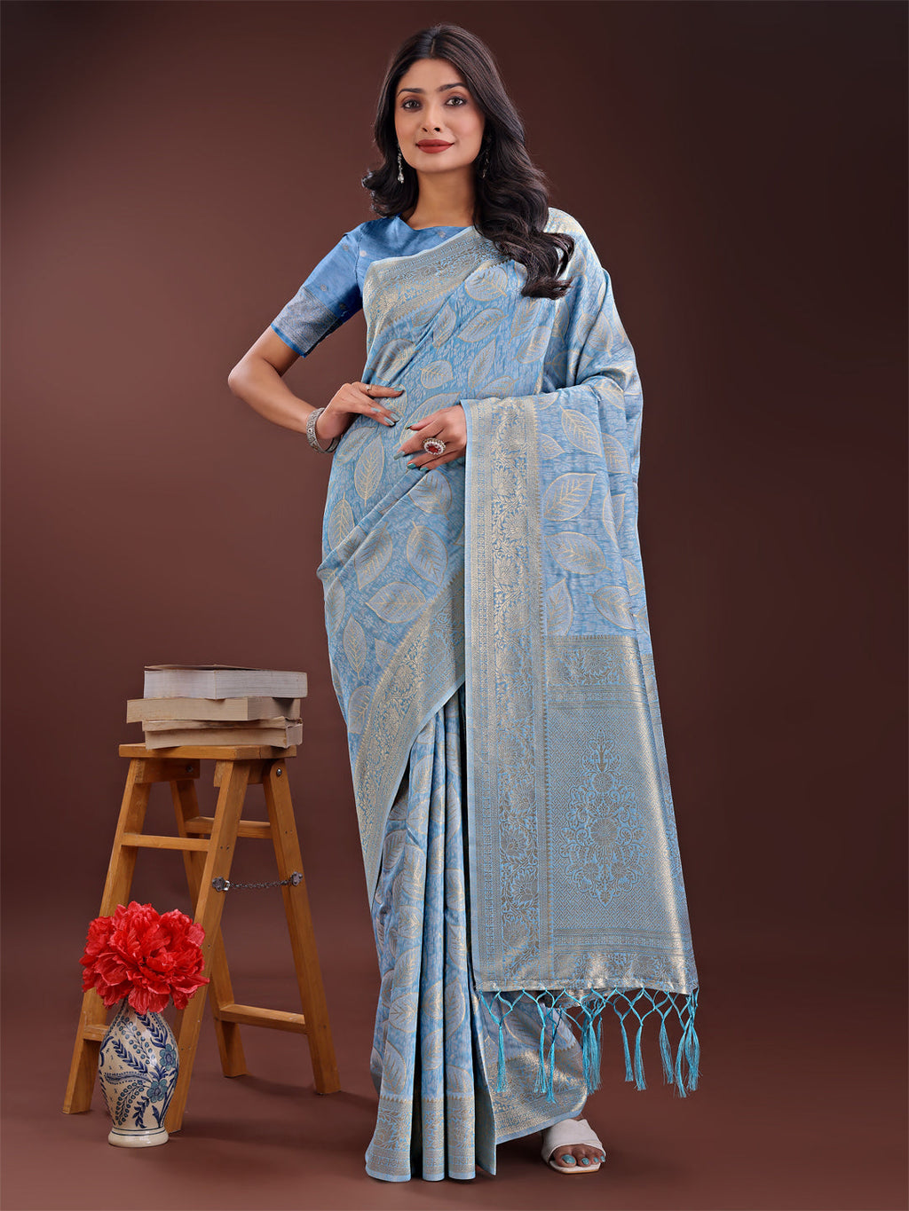 A sky blue linen cotton saree featuring golden zari leaf motifs and an elegant pallu.