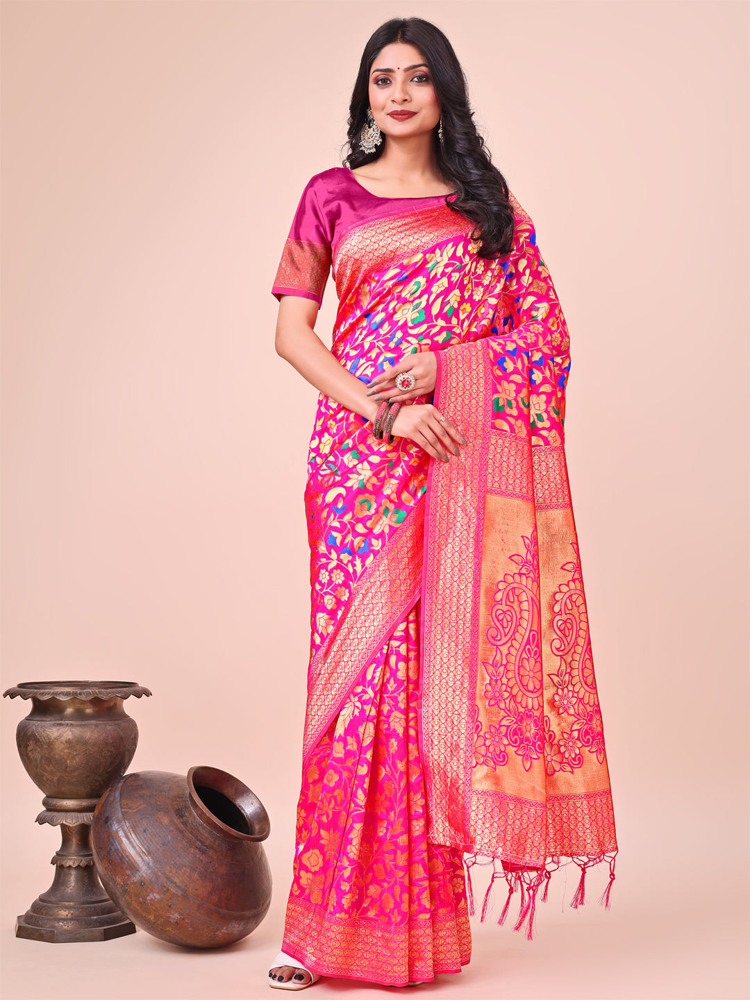 Pink silk saree featuring intricate gold zari floral embroidery and a festive drape