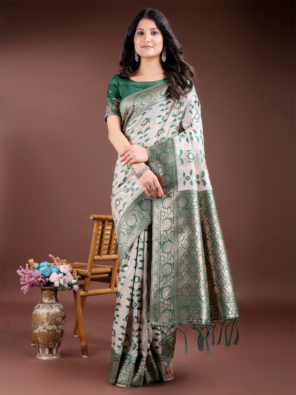 Green linen cotton saree featuring traditional zari work and edge tassels
