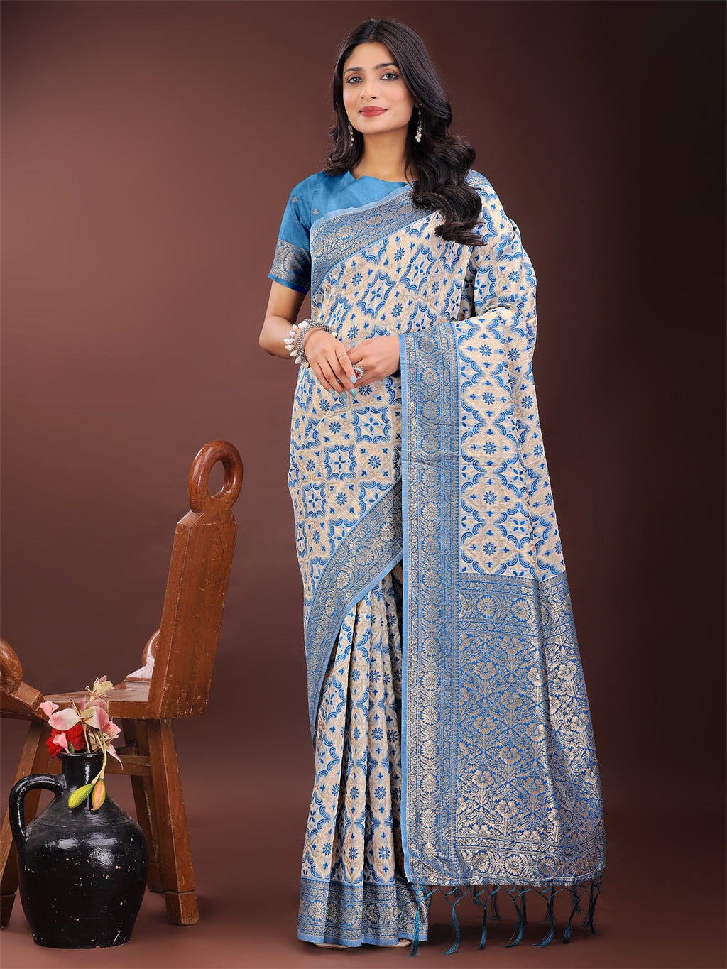 Sky blue linen saree with woven zari floral motifs and a traditional border.