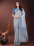 Sky blue linen saree with woven zari floral motifs and a traditional border.
