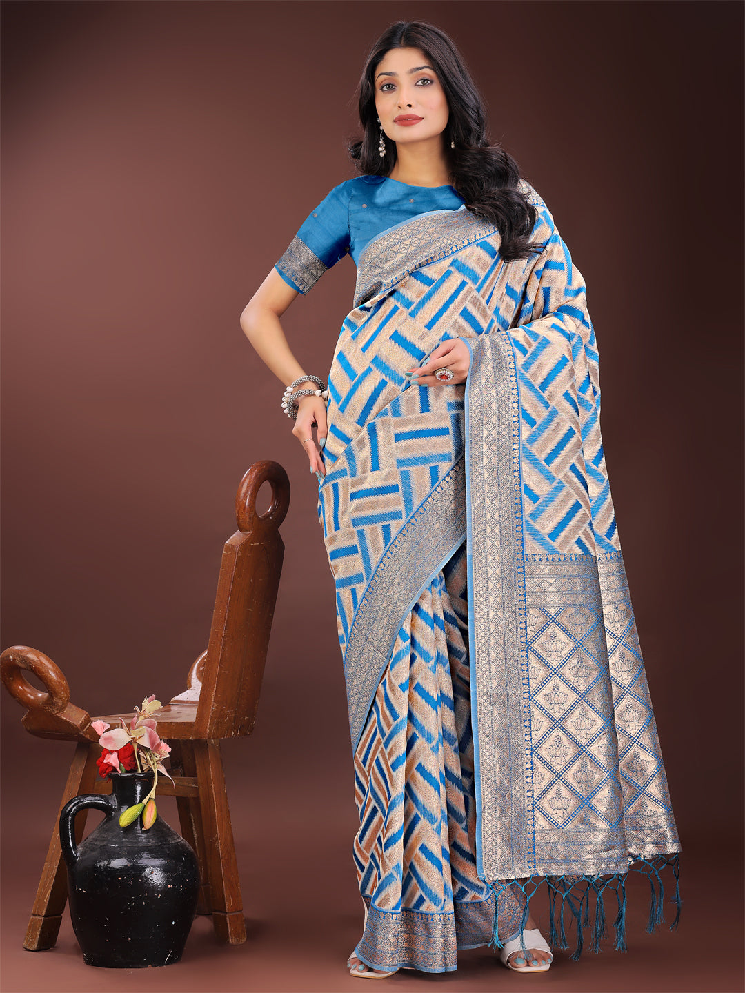 Sky blue and cream linen saree with geometric patterns and a metallic zari border.
