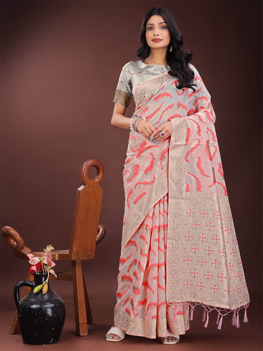 Elegant beige and coral linen saree with abstract patterns and zari detail