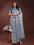 Beige and red linen saree with floral patterns and a gold Zari pallu