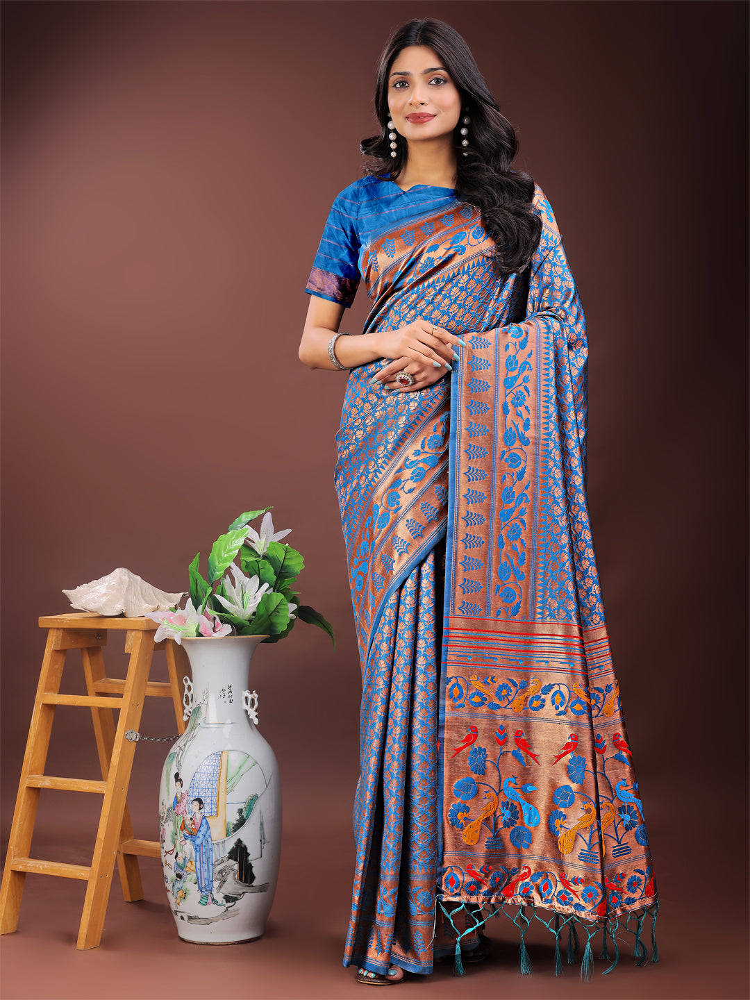 Vibrant copper and blue Banarasi silk saree with a colorful pallu and intricate woven motifs