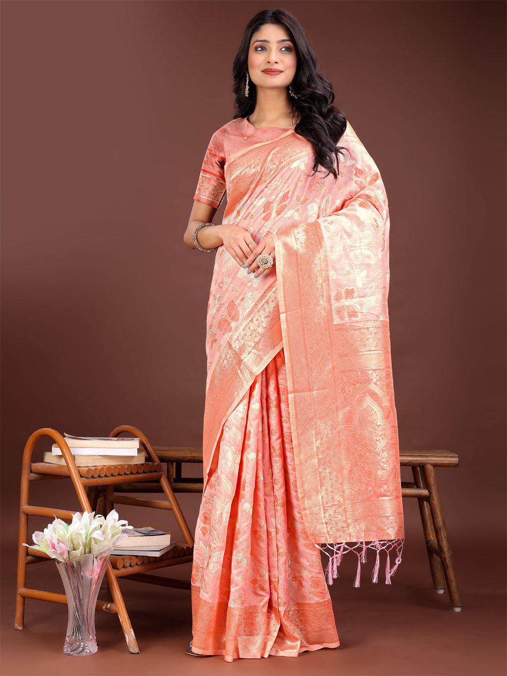 Orange cotton saree adorned with intricate golden zari motifs and a detailed pallu.