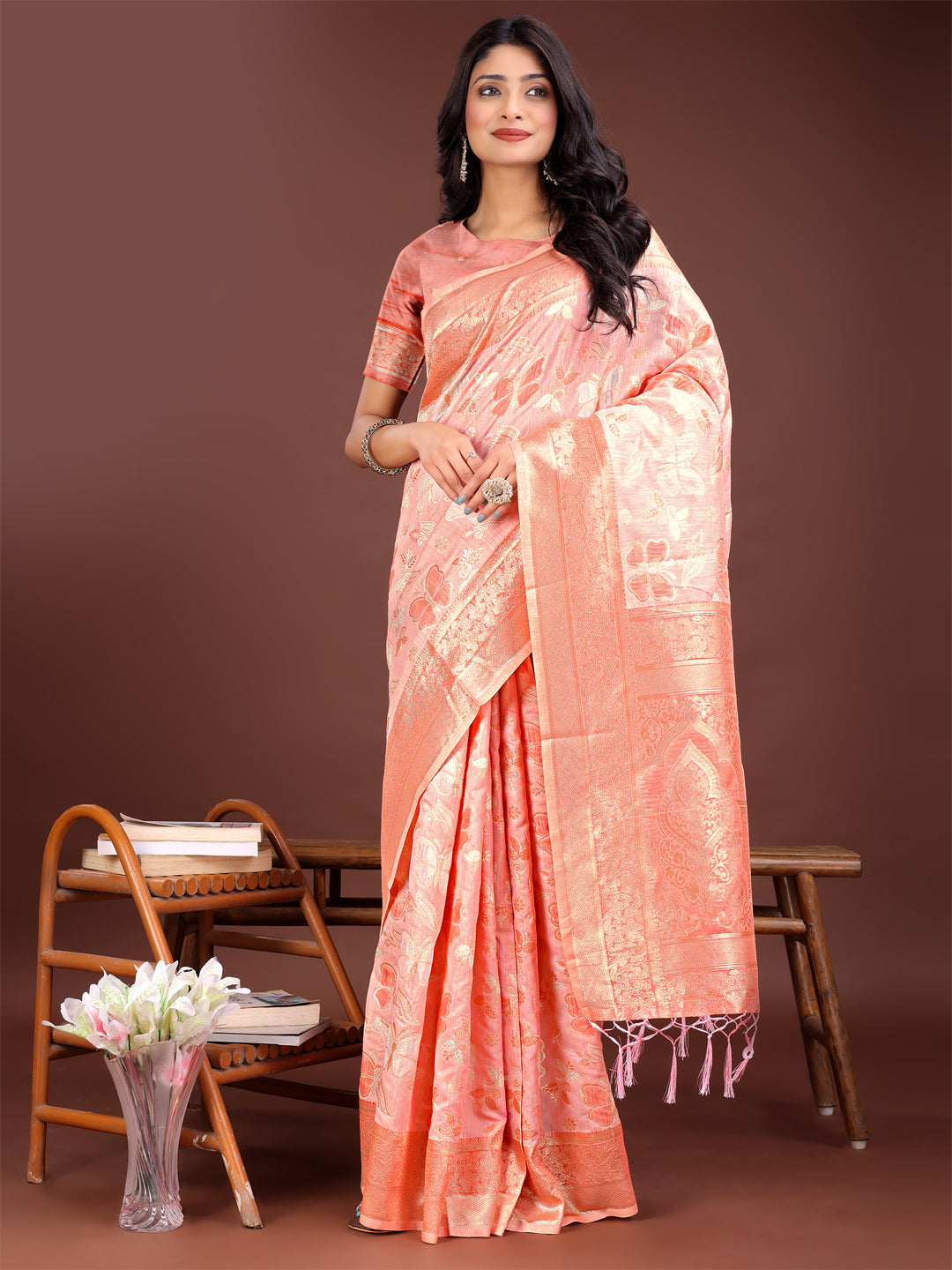 Orange cotton saree adorned with intricate golden zari motifs and a detailed pallu.