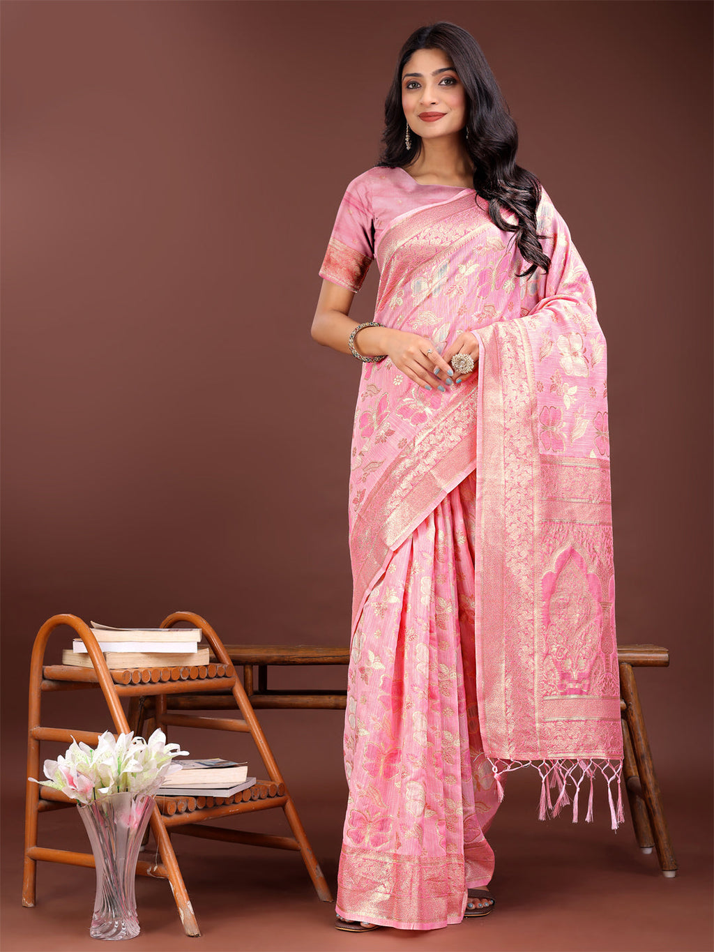 Pink cotton saree with golden zari motifs and a detailed festive pallu