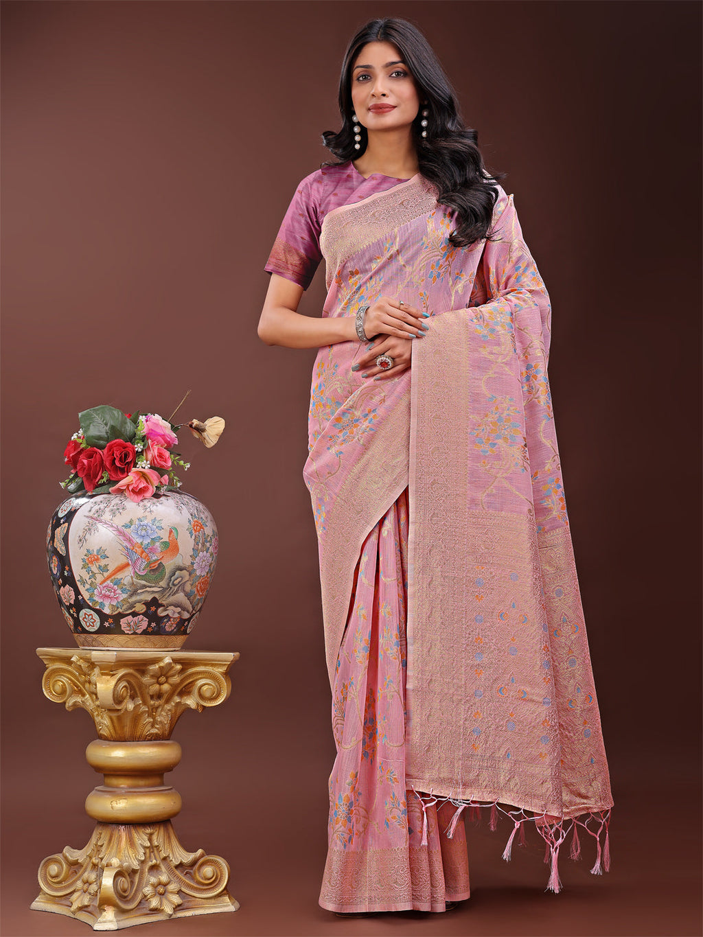 Elegant light pink linen cotton saree with floral patterns and a subtle gold pallu
