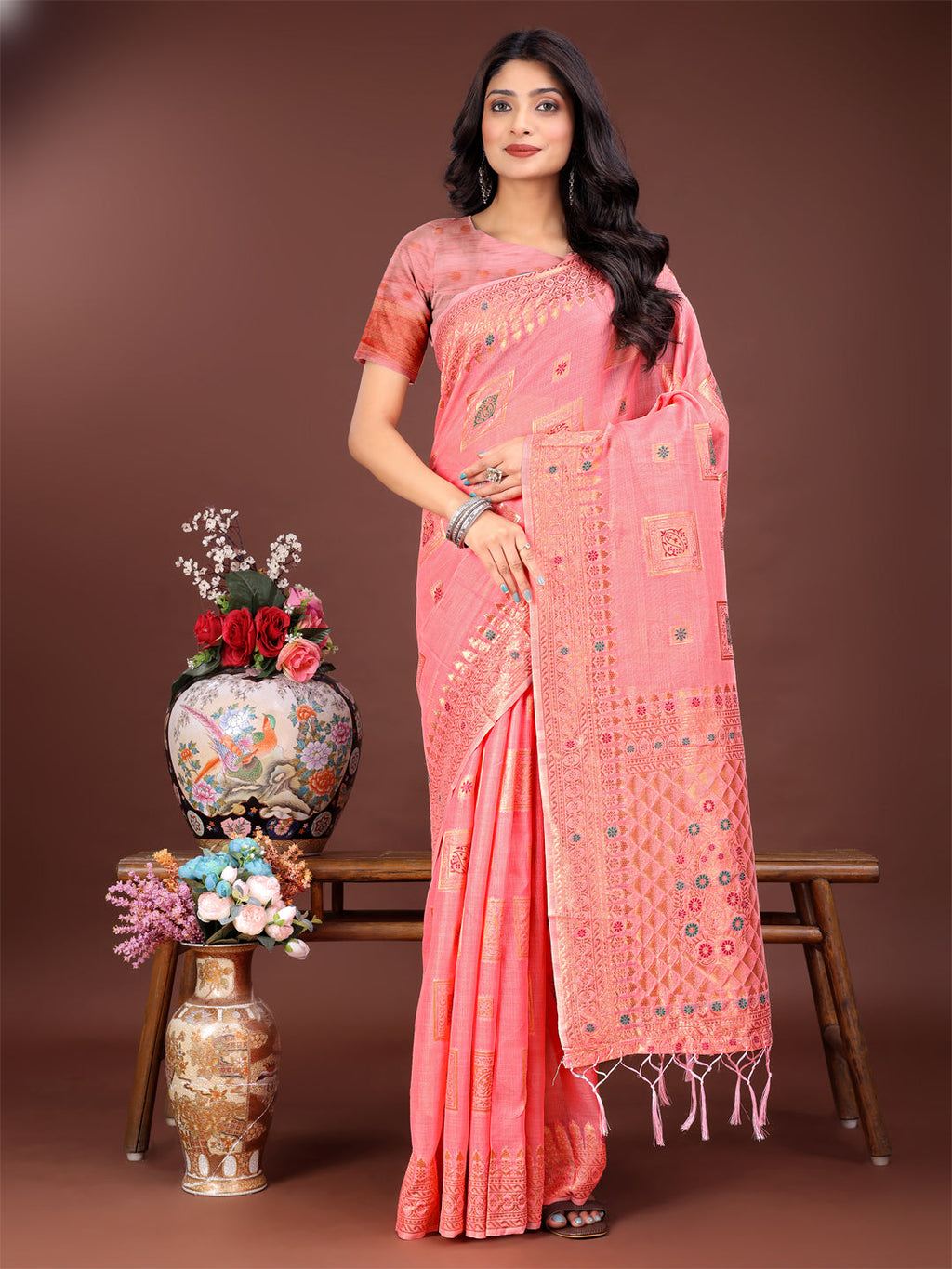 Peach linen saree featuring intricate woven patterns and a detailed pallu.