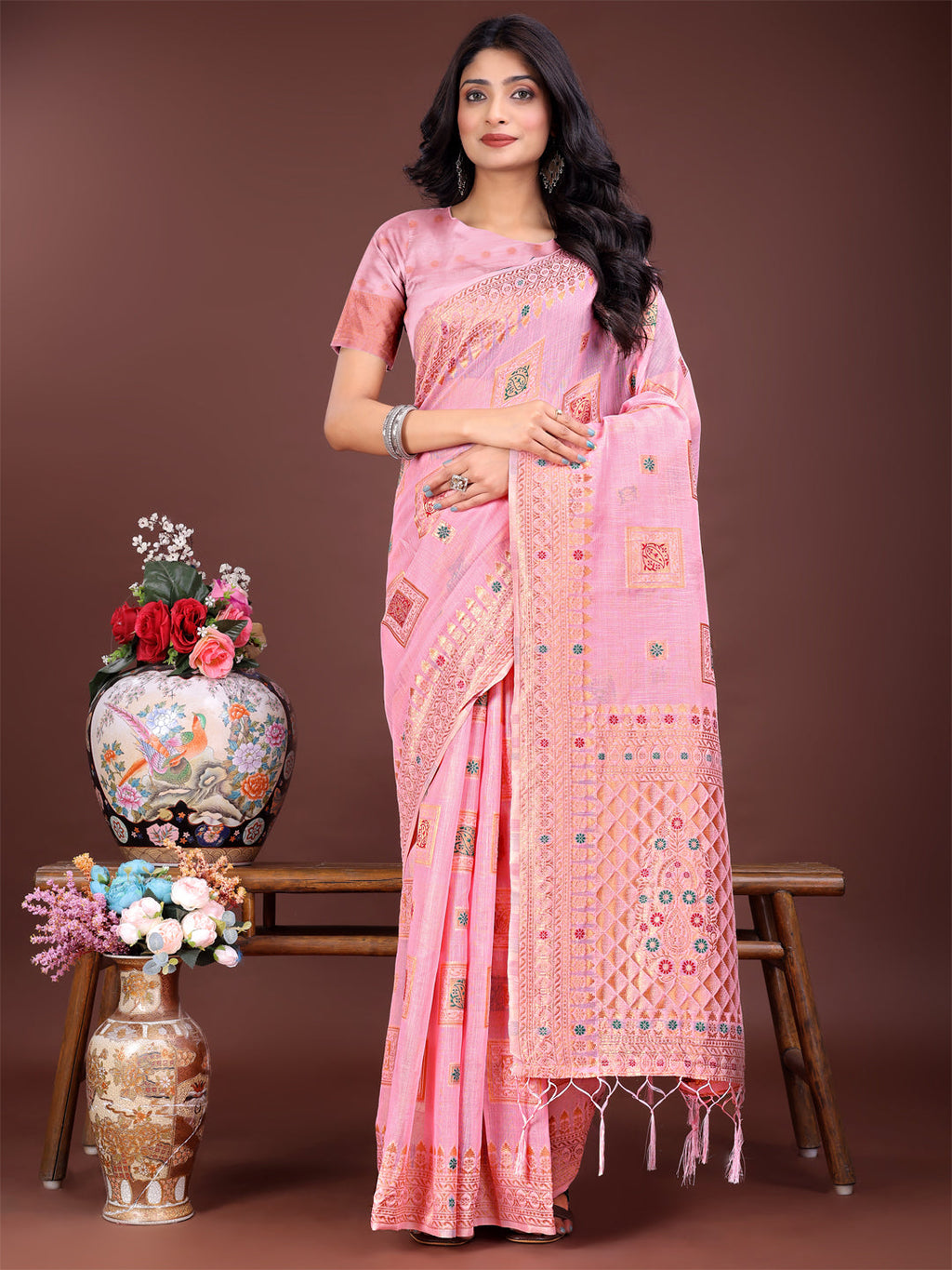 Light pink linen saree with intricate woven motifs and traditional pallu