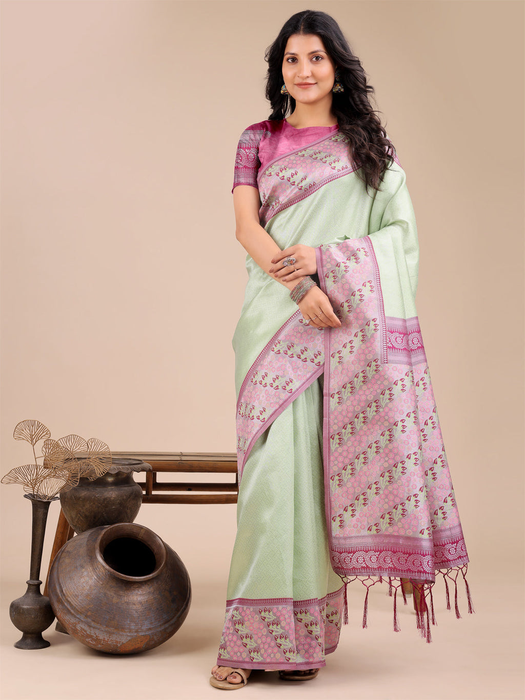 Light green silk saree with soft pink and blue floral motifs