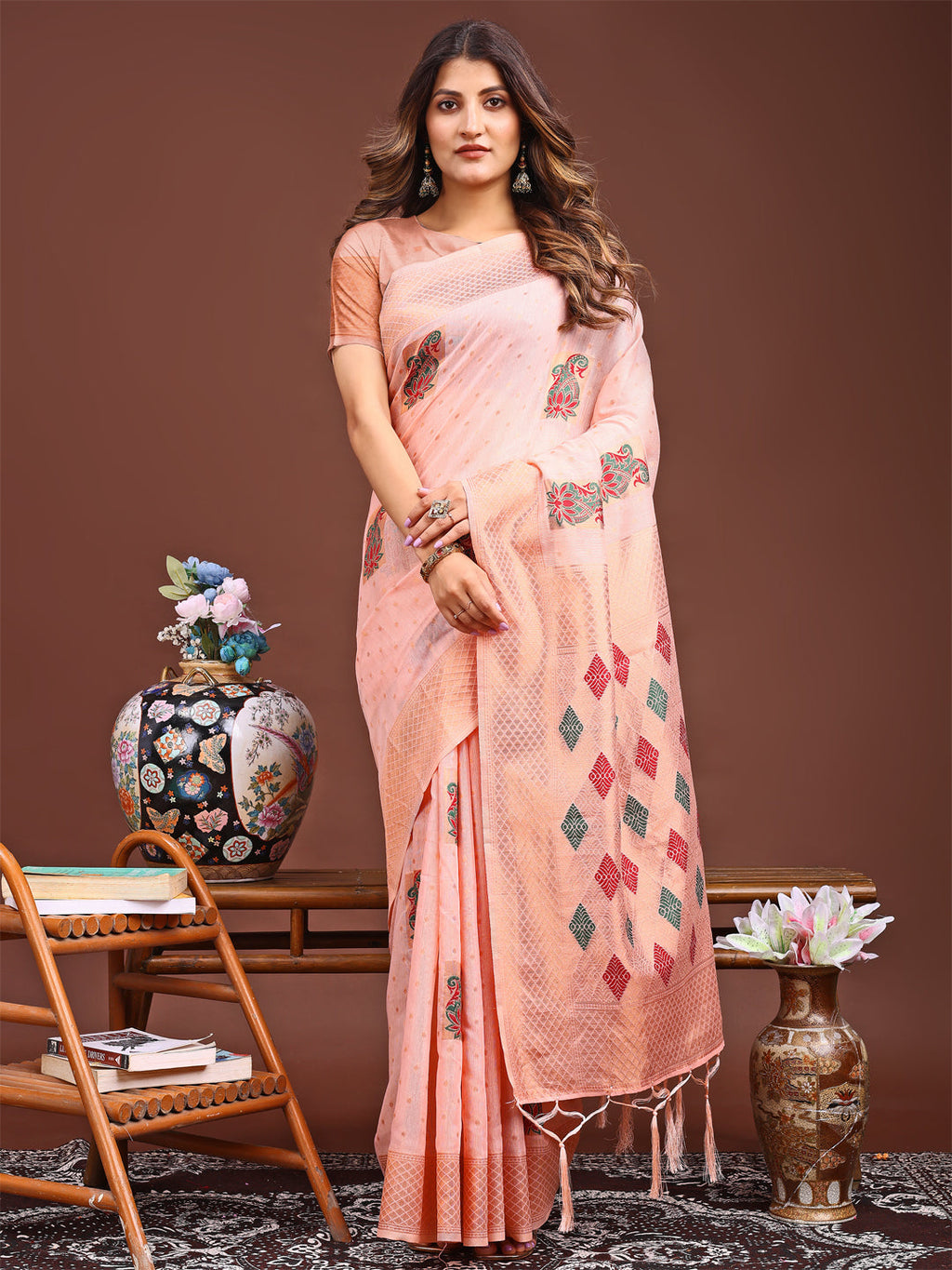 Peach colored jacquard saree with decorative tassel pallu ends