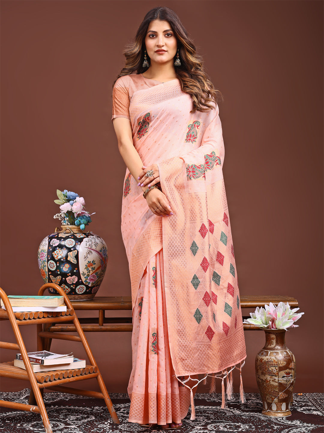 Peach colored jacquard saree with decorative tassel pallu ends