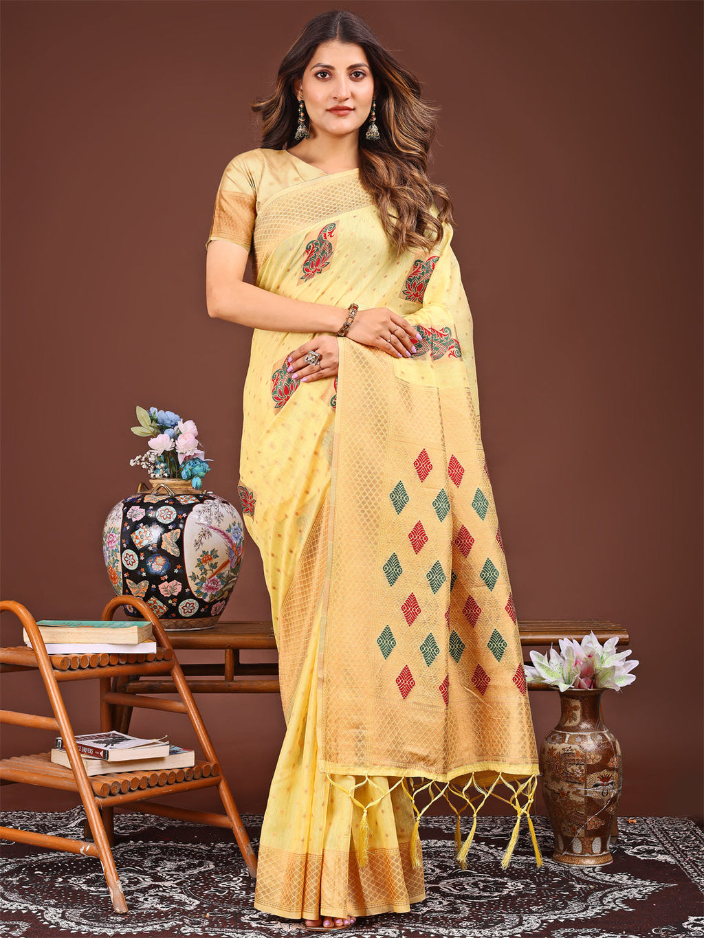 Yellow Jacquard saree featuring decorative tassels and elegant drape