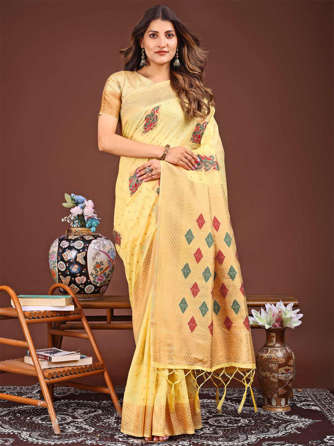 Yellow Jacquard saree featuring decorative tassels and elegant drape